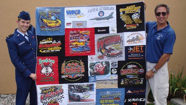 Girl and father holding T-shirt quilt