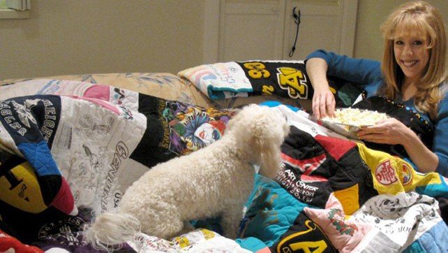 Women and dog snuggled with T-shirt quilt