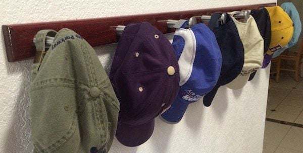 Too Many Baseball caps lined up in a row