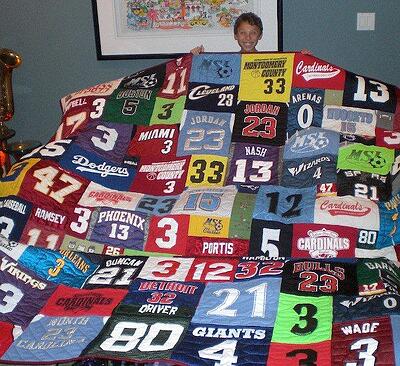 A young boy with a T-shirt quilt full of his player's numbers By Too Cool T-shirt Quilts