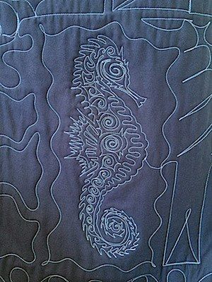 fancy quilting on a T-shirt quilt as seen from the back.