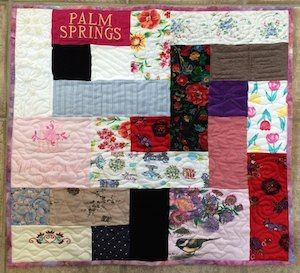 A mini memorial quilt made from clothing. Size - 28 x 28