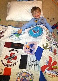cute little boy with a Too Cool T-shirt Quilt.
