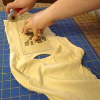 Cutting baby clothes for a T-shirt Quilt Cutting baby clothes for a T-shirt Quilt
