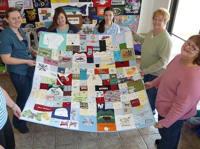 Checking out a baby clothes quilt