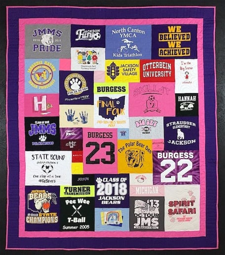 Graduation T-shirt quilt with purple and pink binding.