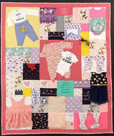 Complex baby clothes quilt made by Too Cool T-shirt Quilts