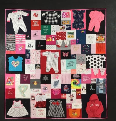 Complex baby clothes quilt made by Too Cool T-shirt Quilts