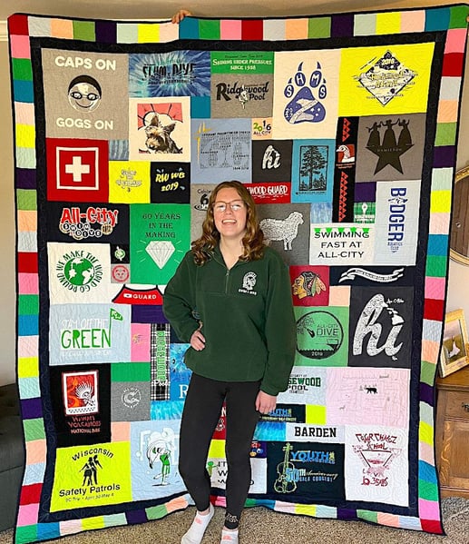 Girl standing in front of quilt with fancy border