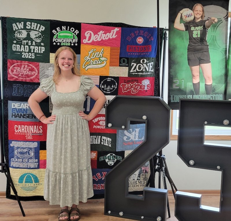 Girl with graduation T-shirt quilt from her party