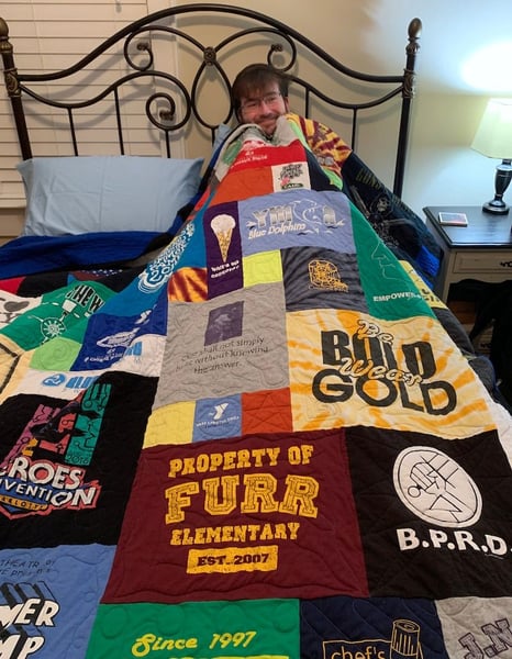 Guy in bed with his Too Cool T-shirt Quilts