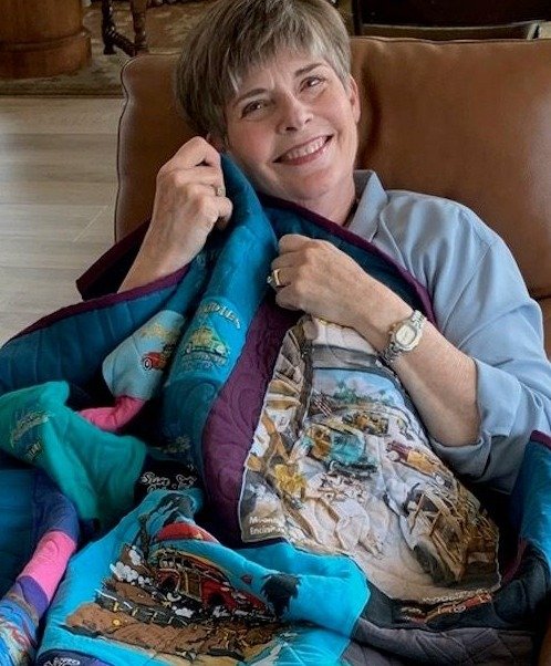 Happy with T-shirt quilt sitting in chair 2-1