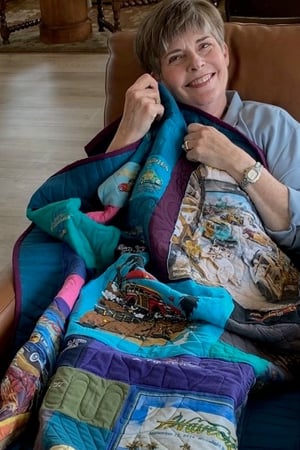 Happy with T-shirt quilt sitting in chair 3