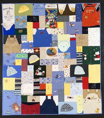 Baby clothes quilt with lots of hats