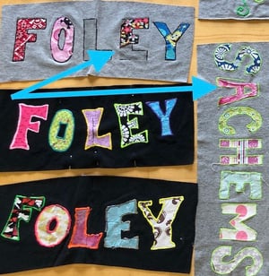 Homemade letters on a T-shirt coming off before they are put into a quilt