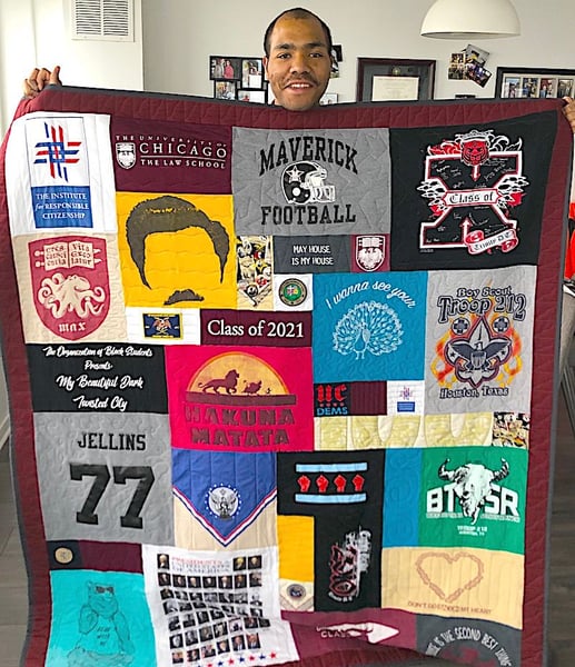 Man holding quilt with 2 border by Too Cool T-shirt Quilts