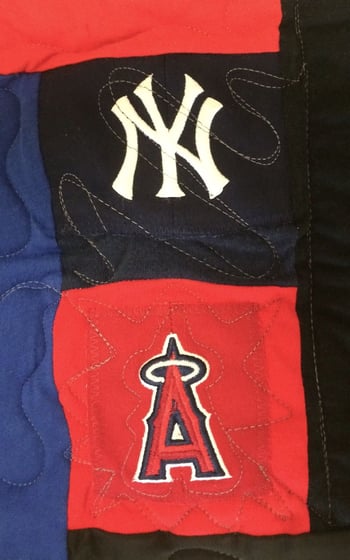 two baseball caps mixed in with T-shirt in a T-shirt quilt