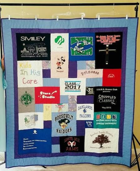 A T-shirt quilt hung with commercial pant hangers