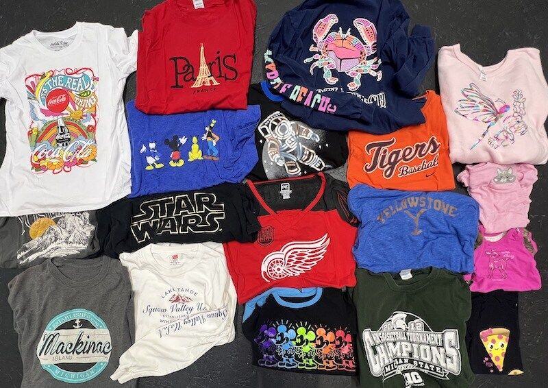 Pile of shirts laid out for Graduation T-shirt quilt by Too Cool T-shirt Quilt