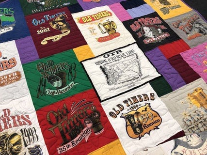 Piping on centered block in a T-shirt quilt