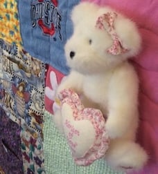 Stuffed bear on memory quilt by Too cool T-shirt quilts