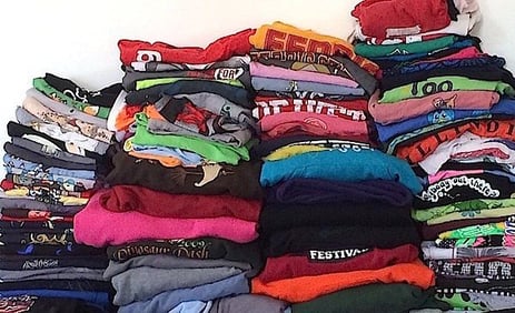 A huge pile of T-shirts ready for a quilt