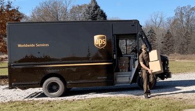 UPS guy delivering boxes of T-shirts to Too Cool T-shirt Quilts