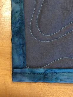 back of binding on a T-shirt quilt - looks great