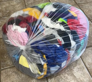 bag of scraps left over from making a T-shirt quilt - Too Cool T-shirt Quilts