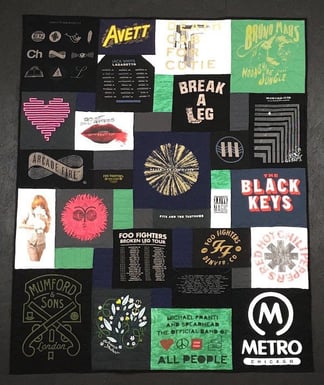 A concert T-shirt quilt where the green and white shirts are balanced with the black T-shirts.  