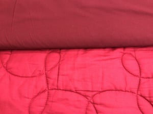 In the photo here, the top color is crimson. It's a dark maroon-red. The bottom color is the campus quilt with the "crimson" backing color