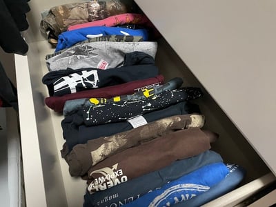 dresser drawer of T-shirts for a A Too Cool T-shirt quilt 