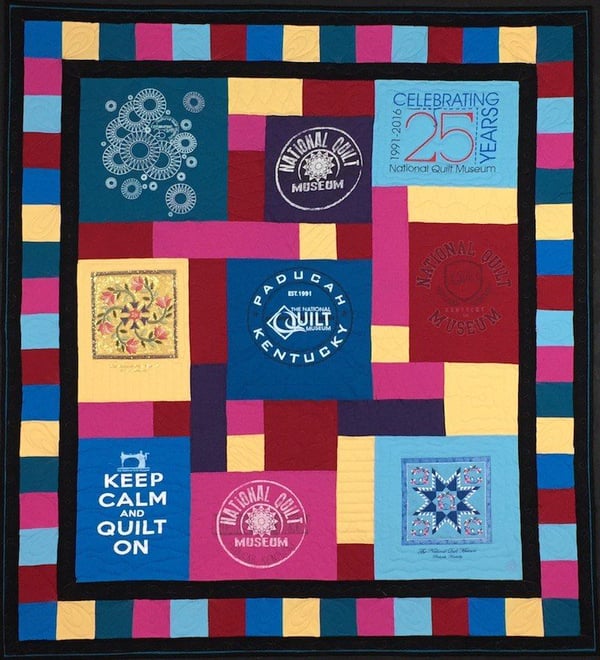 a photo of a T-shirt quilt taken flat on a stage.