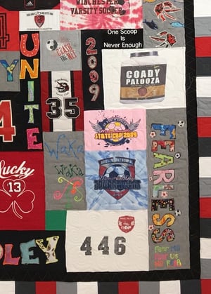 This is a section of a T-shirt quilt that shows many different size blocks used in one quilt.