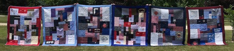 6 memorial quilts made from clothing lined up