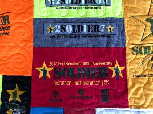 T-shirt quilt with a block covered up with a new T-shirt. 