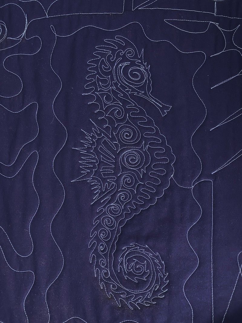 seahorse tracking back to front. long-arm machine quilting on a T-shirt quilt by Too Cool T-shirt Quilts