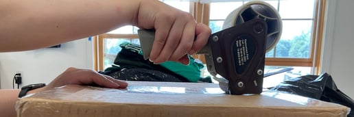 taping up box at Too Cool T-shirt quilts - a quilt is on the way home