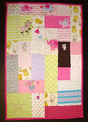 The quilt here is made from baby clothes. The size is 24" x 36".