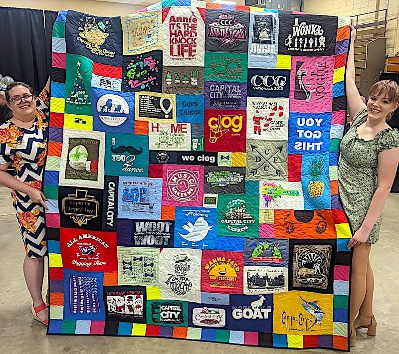 Happy daughter with graduation T-shirt quilt by Too Cool T-shirt Quilts